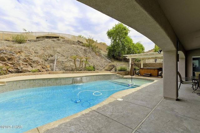 pool featuring a hot tub, stairs, and a patio