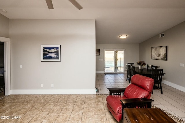 sitting room featuring light tile patterned flooring and lofted ceiling