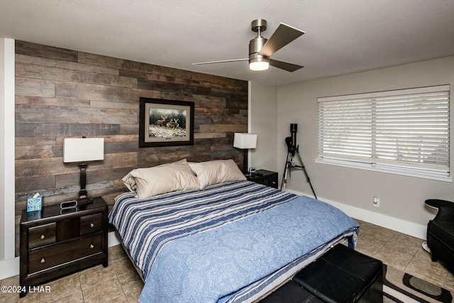 tiled bedroom featuring wooden walls and ceiling fan