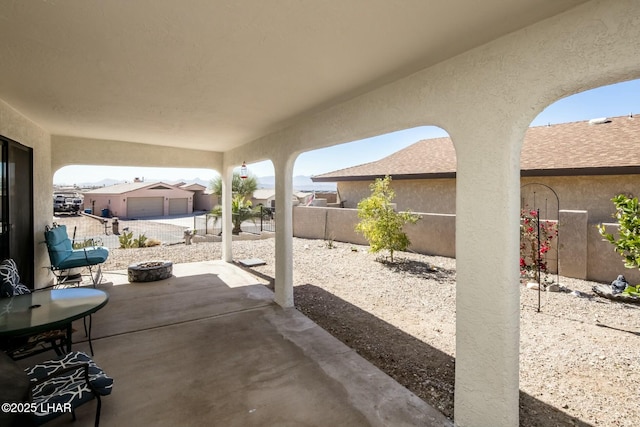 view of patio / terrace featuring fence and an outdoor structure