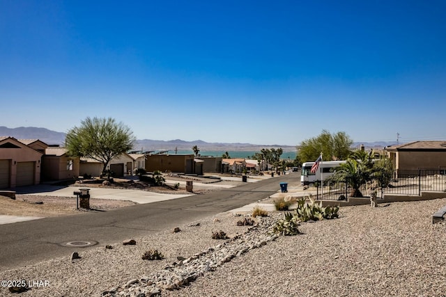 view of yard featuring fence and a mountain view