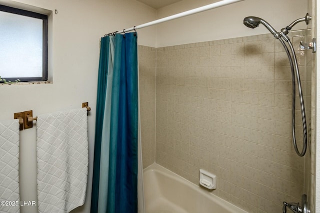 bathroom with shower / bath combination with curtain