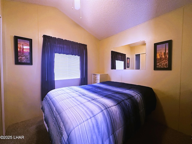 bedroom featuring ceiling fan, lofted ceiling, and a textured ceiling