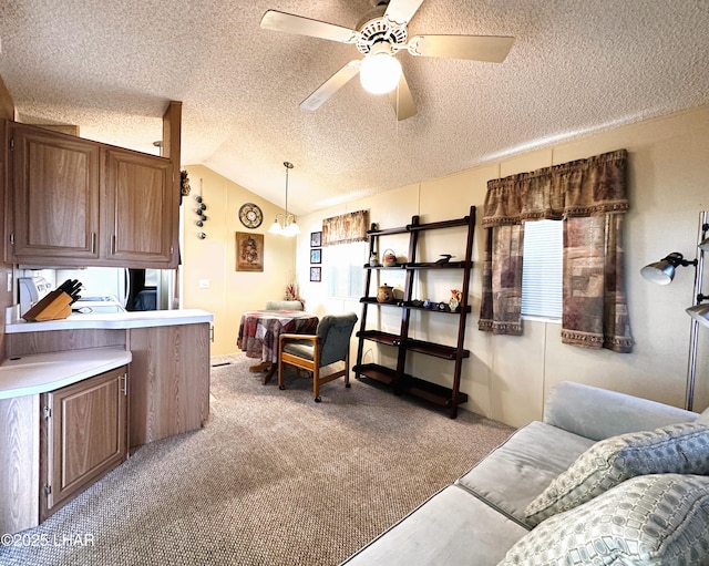 carpeted living room featuring ceiling fan, vaulted ceiling, and a textured ceiling