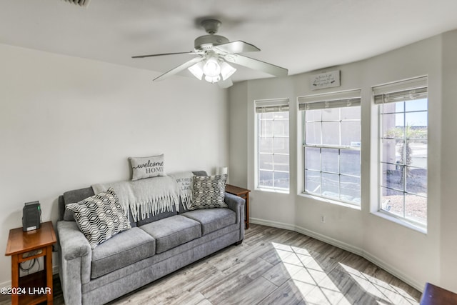 living room with ceiling fan and light wood-type flooring