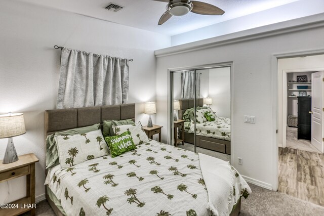 carpeted bedroom featuring a closet and ceiling fan