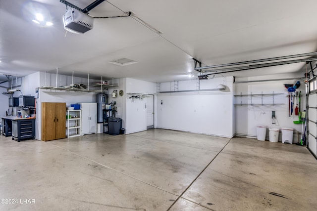 garage featuring a garage door opener and electric water heater