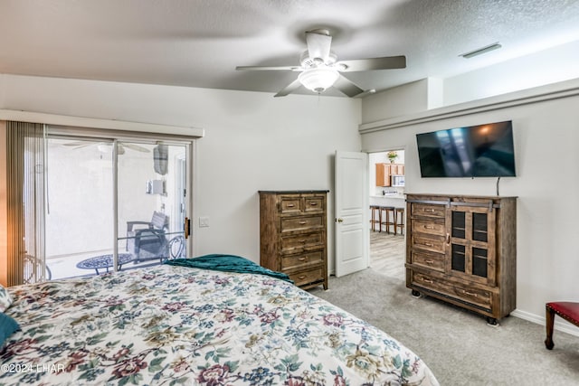 carpeted bedroom with ceiling fan, multiple windows, a textured ceiling, and access to outside