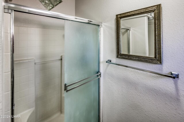 bathroom with a shower with shower door