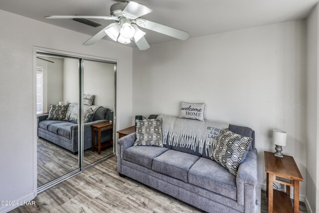 living room with hardwood / wood-style floors and ceiling fan