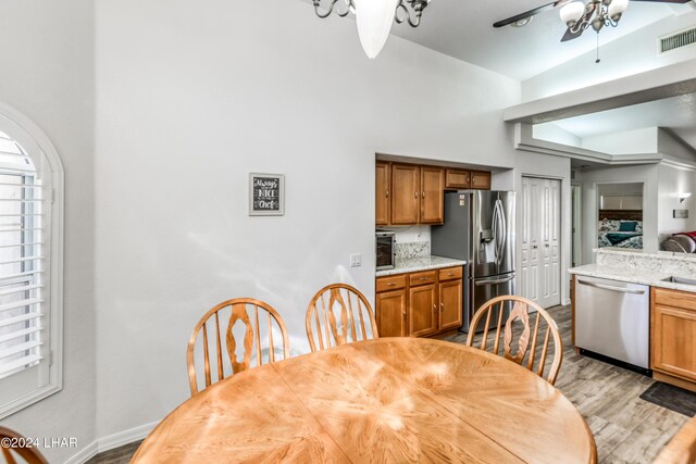 dining area with ceiling fan and light hardwood / wood-style floors