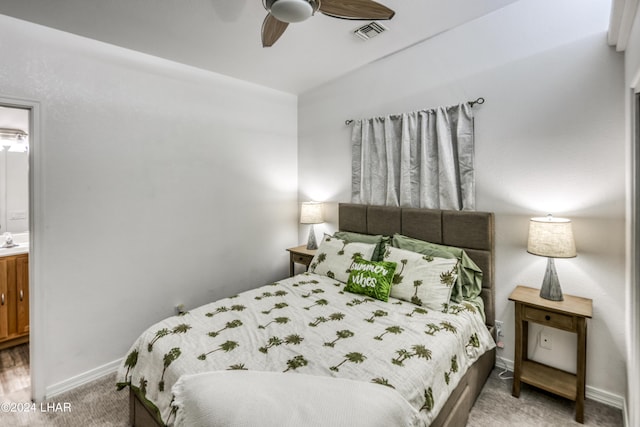 carpeted bedroom featuring sink, ceiling fan, and ensuite bath