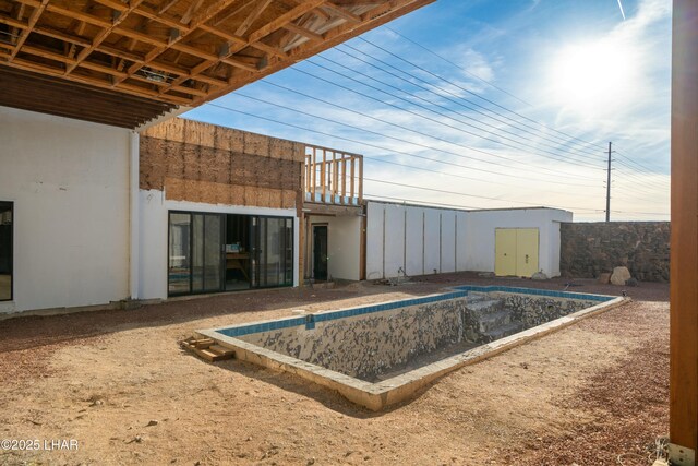 view of swimming pool featuring a storage shed and an outbuilding