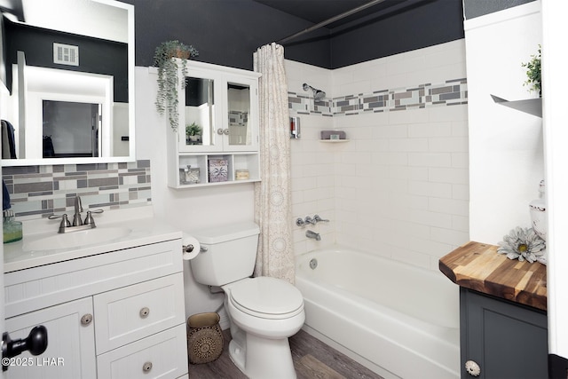 full bathroom featuring toilet, tasteful backsplash, shower / tub combo, vanity, and hardwood / wood-style flooring