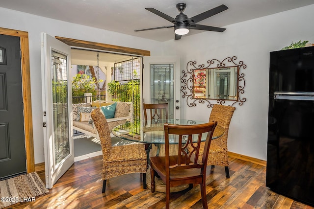 dining room with ceiling fan and dark hardwood / wood-style flooring