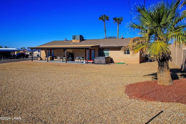 back of property featuring central AC and a patio area