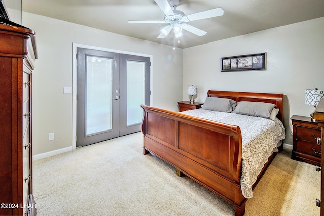 bedroom with light carpet, access to exterior, french doors, and ceiling fan