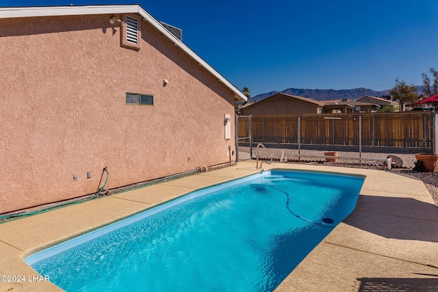 view of swimming pool featuring a mountain view