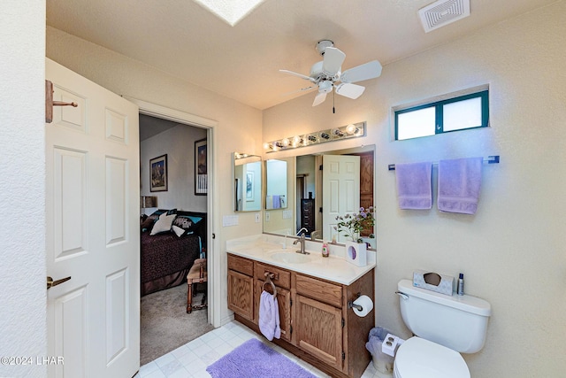 bathroom with vanity, ceiling fan, and toilet