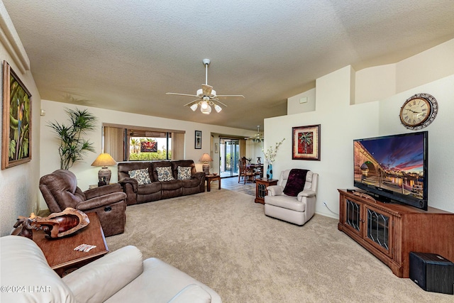 living room featuring a textured ceiling, vaulted ceiling, light colored carpet, and ceiling fan