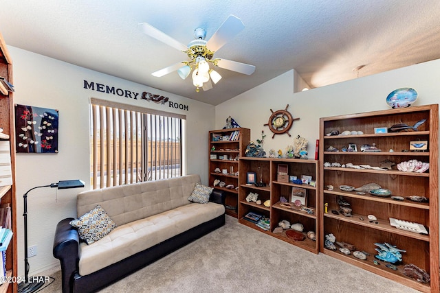 living room featuring ceiling fan, vaulted ceiling, light colored carpet, and a textured ceiling