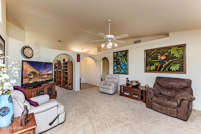 living room featuring lofted ceiling, ceiling fan, and carpet flooring