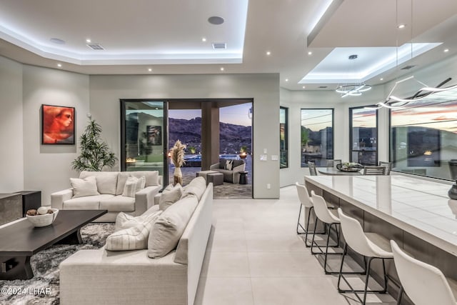 tiled living room with a raised ceiling