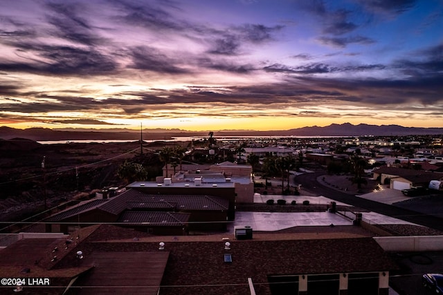 aerial view at dusk featuring a mountain view