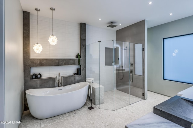 bathroom with plus walk in shower and tile walls