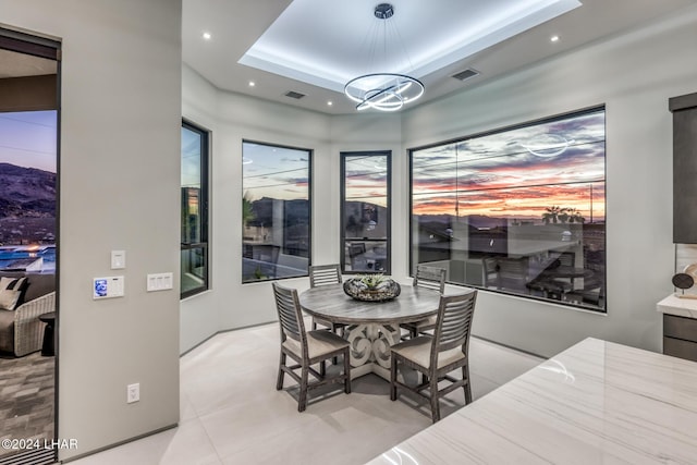 dining room with a raised ceiling