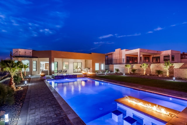 pool at dusk with pool water feature