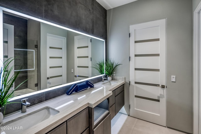 bathroom featuring tile patterned flooring, vanity, and walk in shower