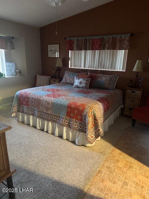 bedroom featuring vaulted ceiling and carpet floors