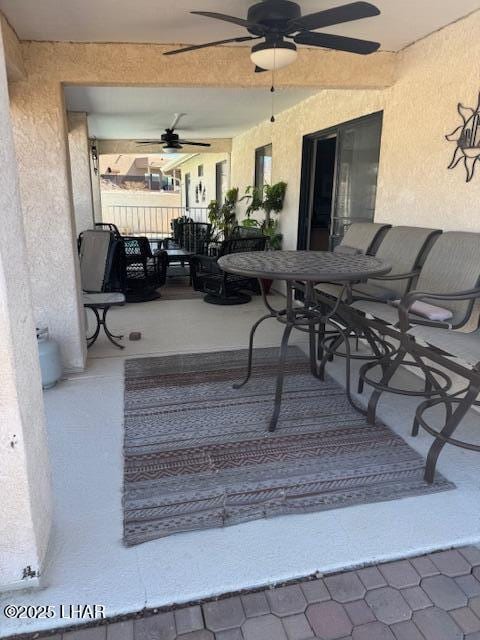 view of patio / terrace featuring outdoor dining area, fence, and ceiling fan