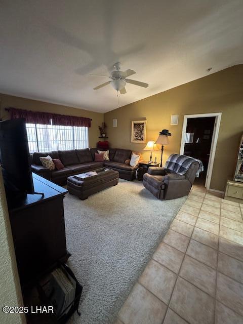 living area featuring light tile patterned floors, lofted ceiling, and ceiling fan