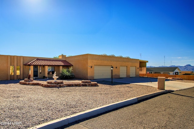 pueblo-style home featuring a garage