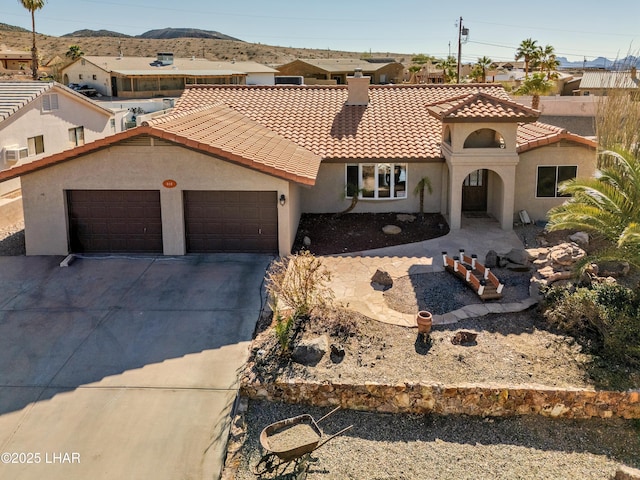 mediterranean / spanish-style house with a garage