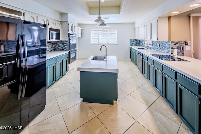 kitchen with decorative light fixtures, black appliances, white cabinetry, sink, and a tray ceiling