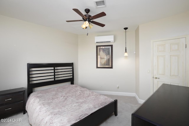 bedroom featuring a wall unit AC and light carpet