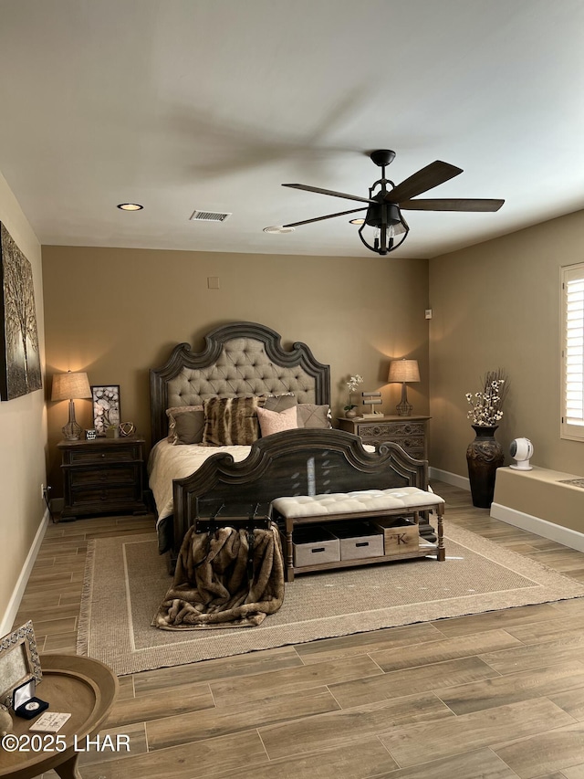 bedroom featuring hardwood / wood-style flooring and ceiling fan