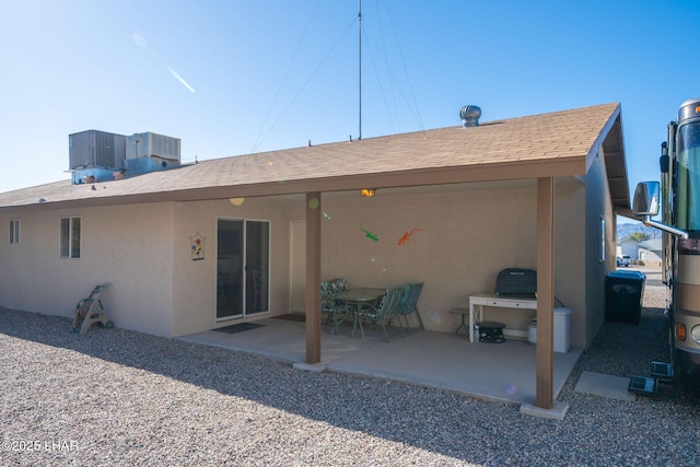 back of property featuring a patio, cooling unit, and stucco siding