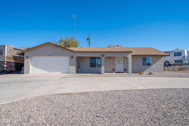 single story home featuring concrete driveway, a garage, and stucco siding