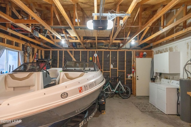 garage with washer and dryer, gas water heater, and a garage door opener