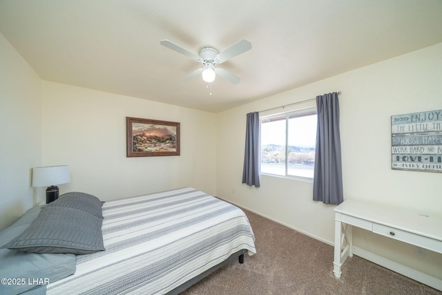 carpeted bedroom featuring ceiling fan and baseboards