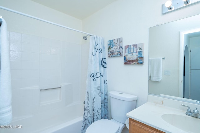 bathroom with shower / bath combo with shower curtain, toilet, and vanity