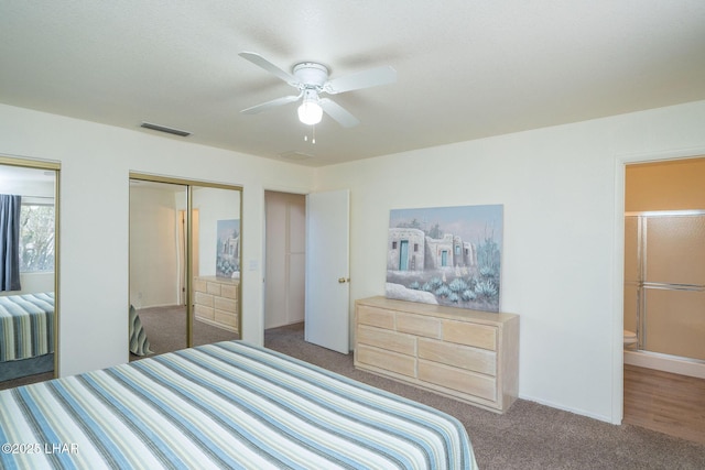 bedroom featuring carpet flooring, a ceiling fan, visible vents, and two closets