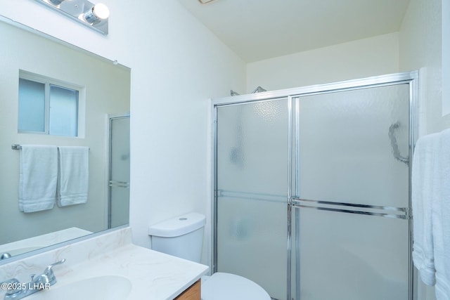 full bath with a shower with shower door, toilet, and vanity