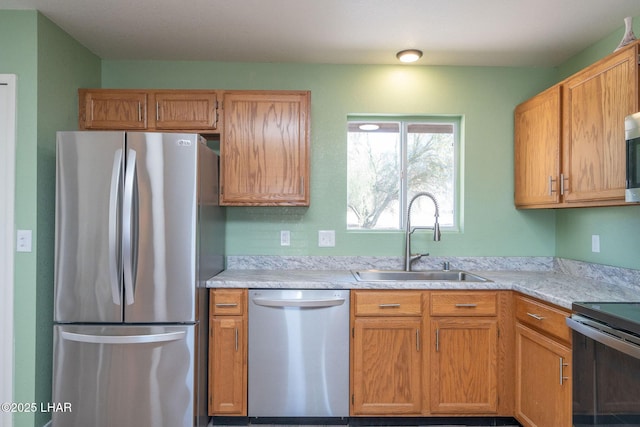 kitchen featuring a sink, appliances with stainless steel finishes, and light countertops