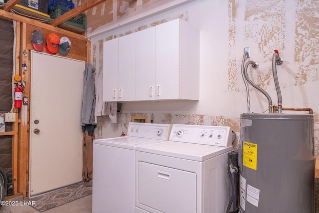 laundry room with cabinet space, electric water heater, and washing machine and dryer