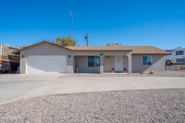 ranch-style home featuring concrete driveway, a garage, and stucco siding